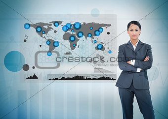Serious businesswoman standing with a digital world map