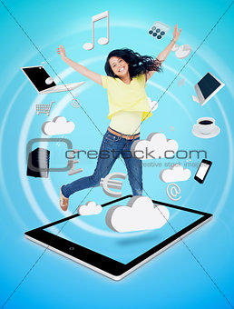 Smiling woman jumping on a tablet pc