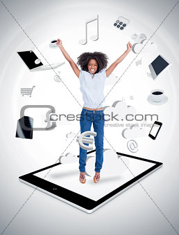 Cheerful woman jumping on a tablet pc