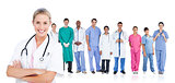 Smiling doctor standing in front of her medical team in line