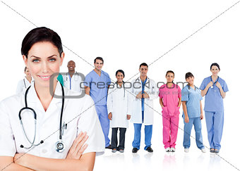 Smiling doctor standing in front of her medical team