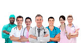 Smiling medical team standing arms crossed in line