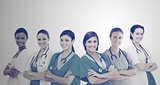 Female hospital workers standing arms folded in line