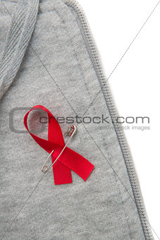 Aids awareness ribbon pinned on to grey hoodie