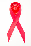 Red aids ribbon with condom
