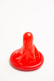 Red condom on white background