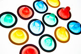Twelve brightly coloured condoms