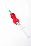 Red ribbon wrapped around syringe