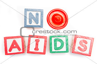 No aids spelled out in blocks and a condom