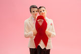 Gay groom cake toppers with red awareness ribbon