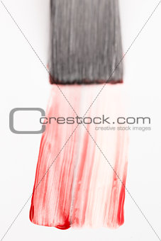 Paintbrush with red brush stroke