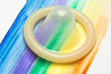 Condom on rainbow brush stroke