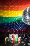 Blocks spelling out gay pride under light of disco ball