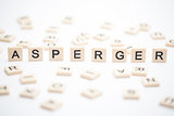 Asperger spelled out in plastic letter pieces with others scattered around