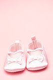 Baby girls pink booties with copy space