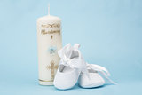 Christening candle for a boy with white baby booties