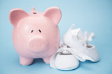 Piggy bank and white baby shoes