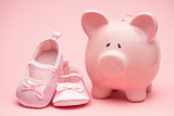 Pink booties and piggy bank