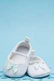 Baby booties with blue ribbon and copy space