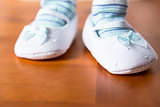 Baby in booties taking first step