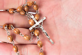Rosary beads in someones hand