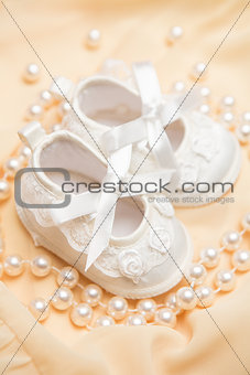 Baby booties on a yellow blanket