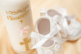 Baptism candle and baby booties