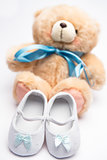 Teddy bear with blue ribbon and white booties