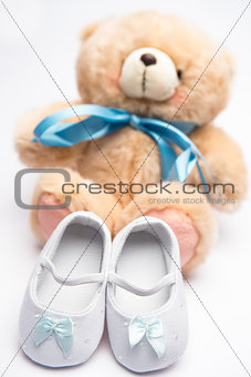 Teddy bear with blue ribbon and white booties