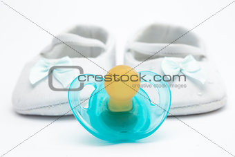 Blue soother with baby booties