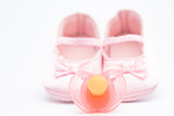 Pink baby booties with pink soother