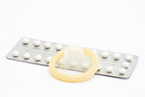 Contraceptive pill and rolled up condom