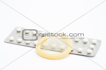Contraceptive pill and rolled up condom