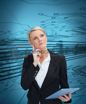 Thoughtful businesswoman holding tablet