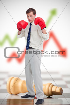 Businessman in boxing gloves on chessboard