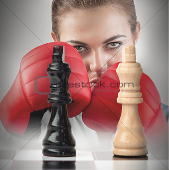 Female boxer behind the chess board