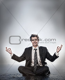 Businessman meditating and smiling