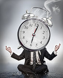 Businessman meditating with face covered by alarm clock