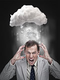 Businessman stressing out under a cloud