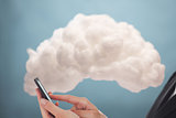 Businesswoman connecting phone to cloud computing