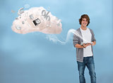Casual young man using tablet for cloud computing