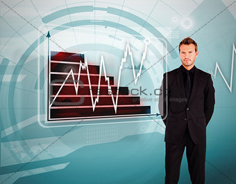 Businessman standing against graph and line display