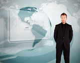 Businessman standing against world map display