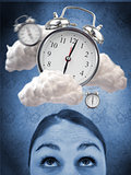 Woman looking up at alarm clock in clouds