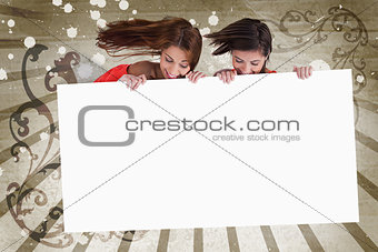 Young girls looking down at white copy space screen
