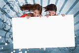 Smiling girls looking down at white copy space screen