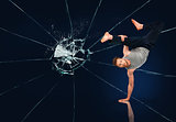 Martial arts expert against broken glass background