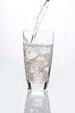 Sparkling water pouring into glass