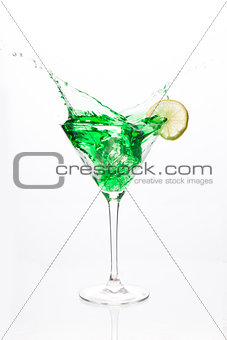 Cocktail glass with green alcohol and lemon
