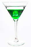 Cocktail glass with green alcohol close up